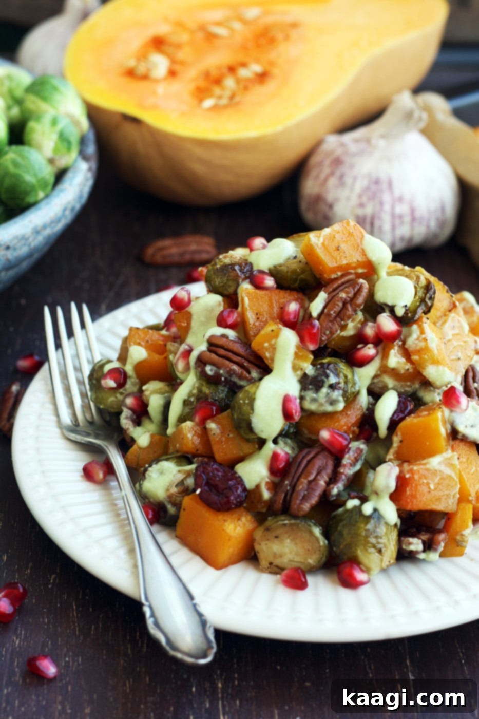 A colorful medley of roasted Brussels sprouts and butternut squash with pecans and cranberries.