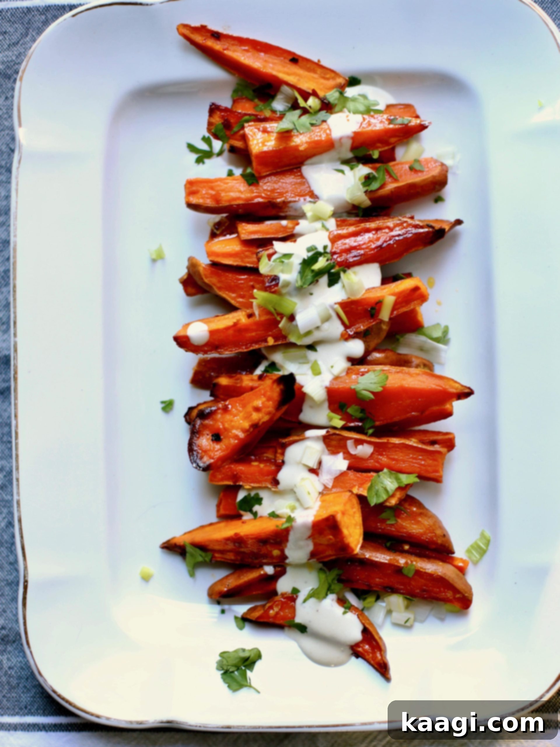 Colorful and spicy roasted sweet potatoes drizzled with a cool yogurt sauce.