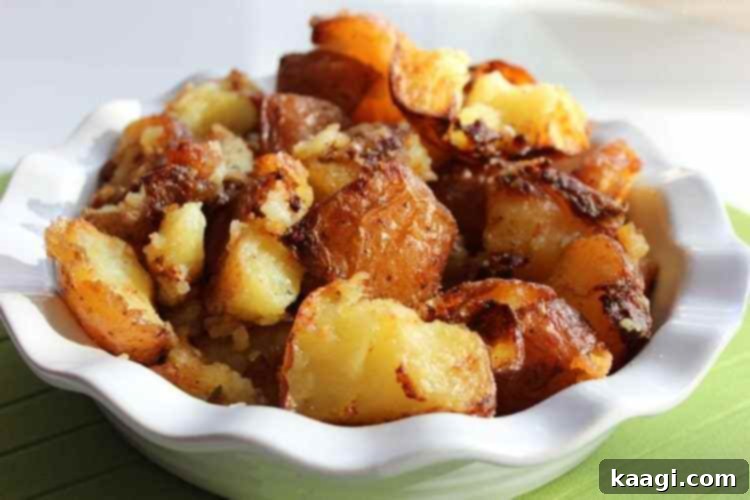 Crispy roast potatoes with garlic, herbs, and Parmesan, golden and aromatic.