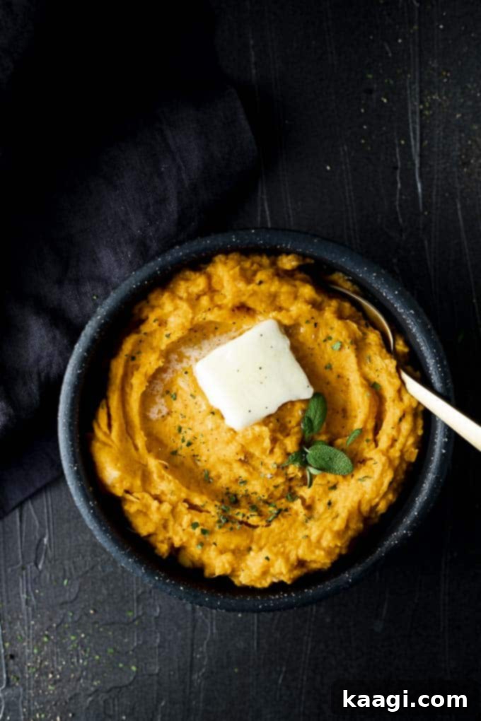 A bowl of rich, savory mashed sweet potatoes with a hint of garlic.
