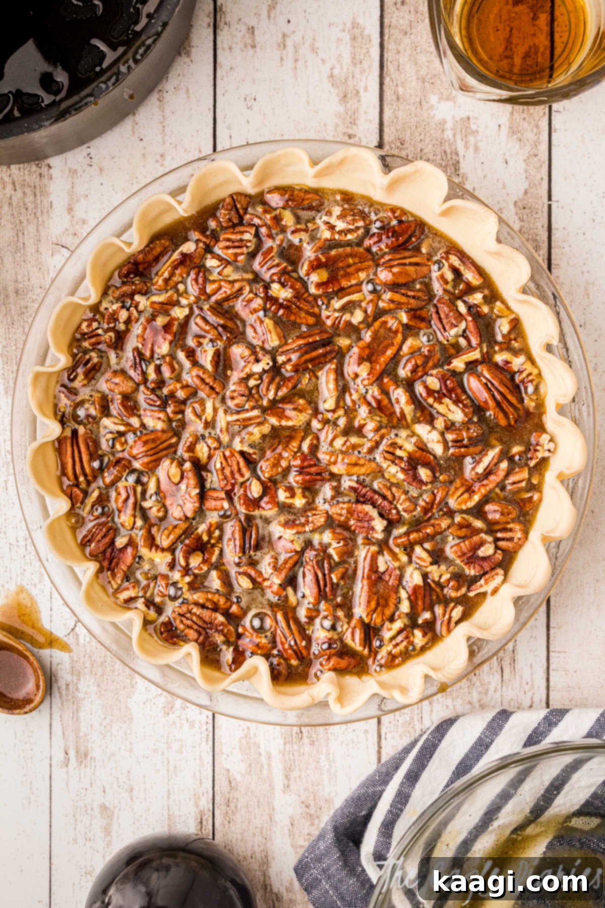 A freshly assembled pecan pie, with its rich filling and pecan topping, placed on a wire rack to cool and set after coming out of the oven.