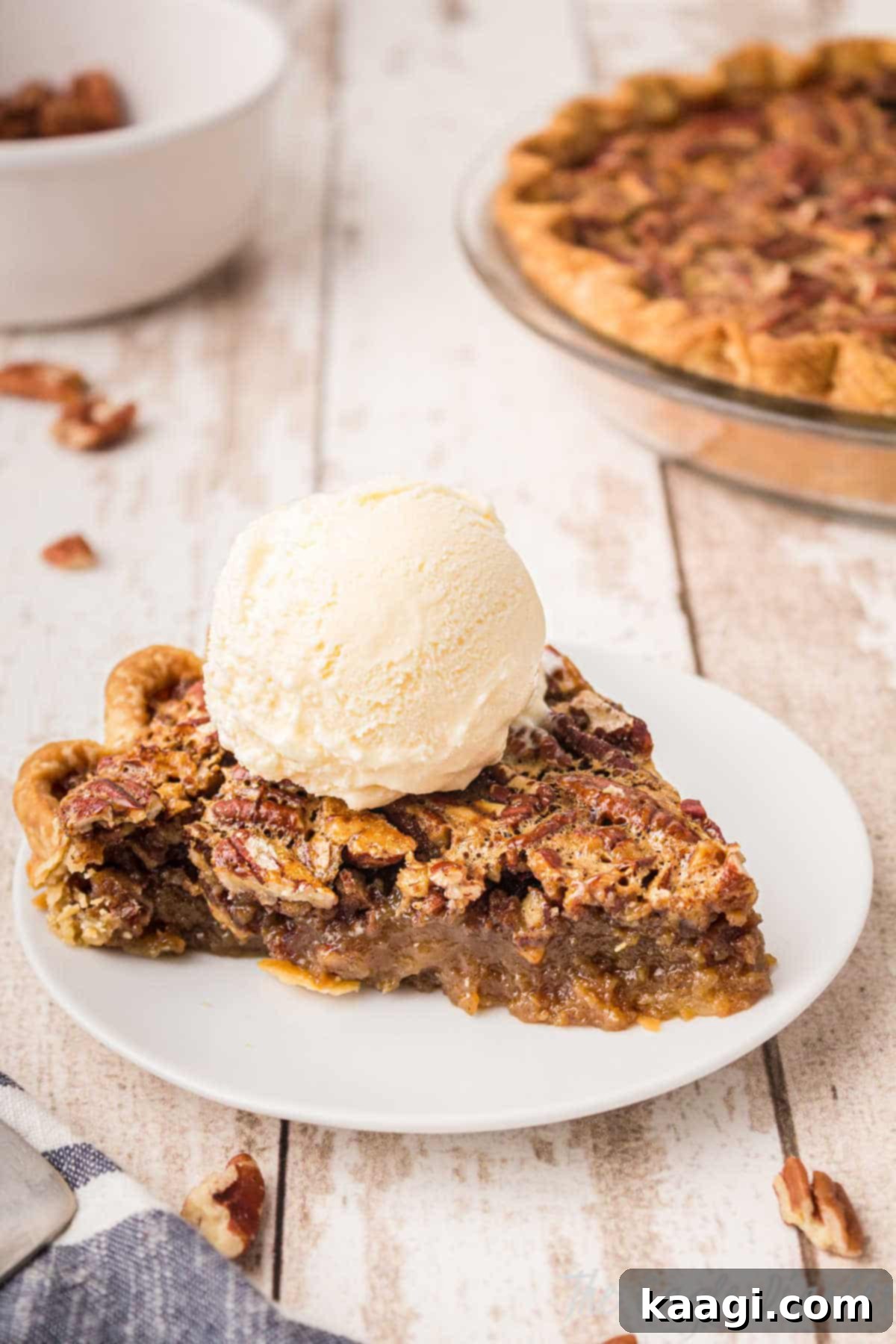 A close-up shot of a perfect slice of Pecan Pie, glistening with its rich, caramel-like filling and topped with a melting scoop of vanilla ice cream, showcasing its irresistible appeal.