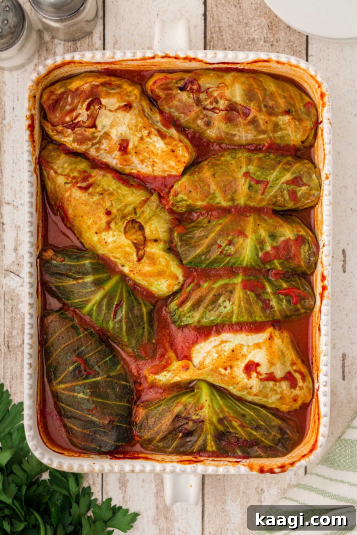 Old-World Cabbage Rolls 2 A beautifully arranged dish of traditional cabbage rolls, generously coated in a luscious, sweet tomato soup sauce, ready to be served. The rolls appear tender and inviting.