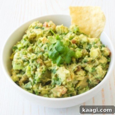 Authentically Mexican Guacamole, vibrant and moreish, perfect for dipping chips on Game Day.