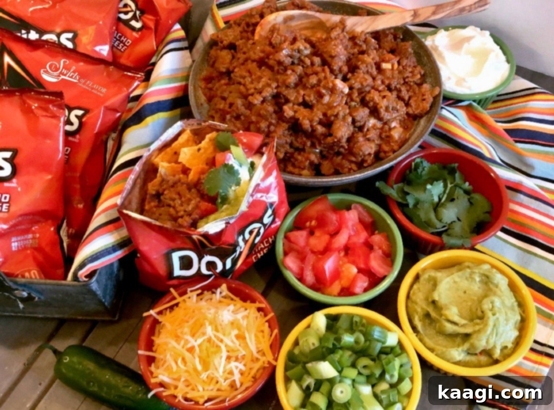 A Walking Taco Bar featuring a saucy taco filling and a variety of toppings served in chip bags.
