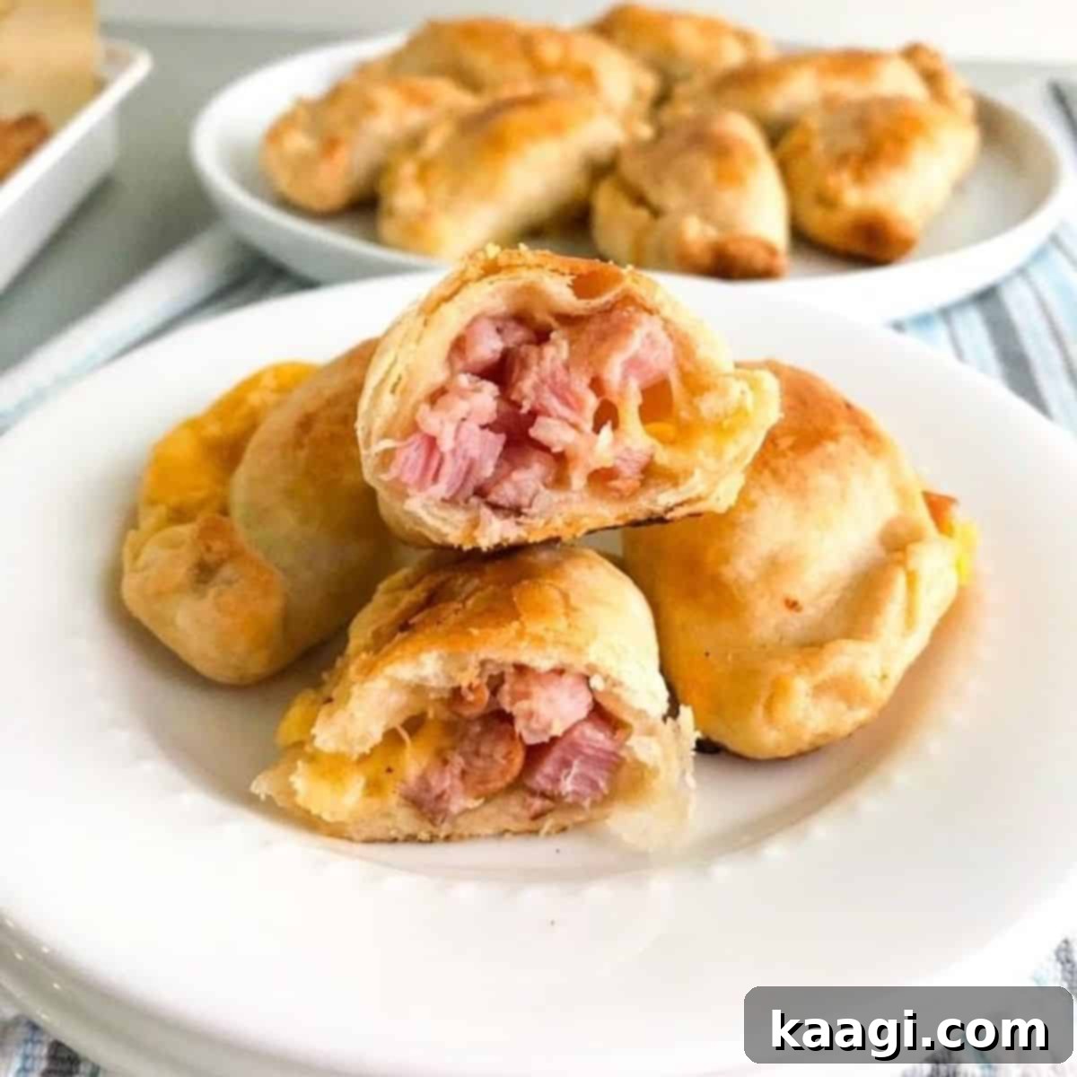 Baked Ham and Cheese Empanadas, crispy, cheesy, and salty, resembling a childhood favorite but even better.