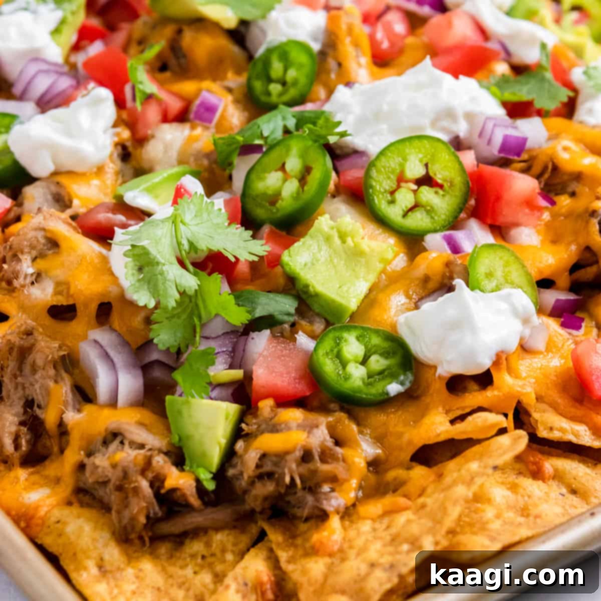 Simple Pulled Pork Nachos, cheesy and piled high, the real winner before halftime.
