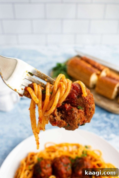 Homecooked Spaghetti and Meatballs, slow-cooked in a crock pot, perfect for Game Day entertaining.