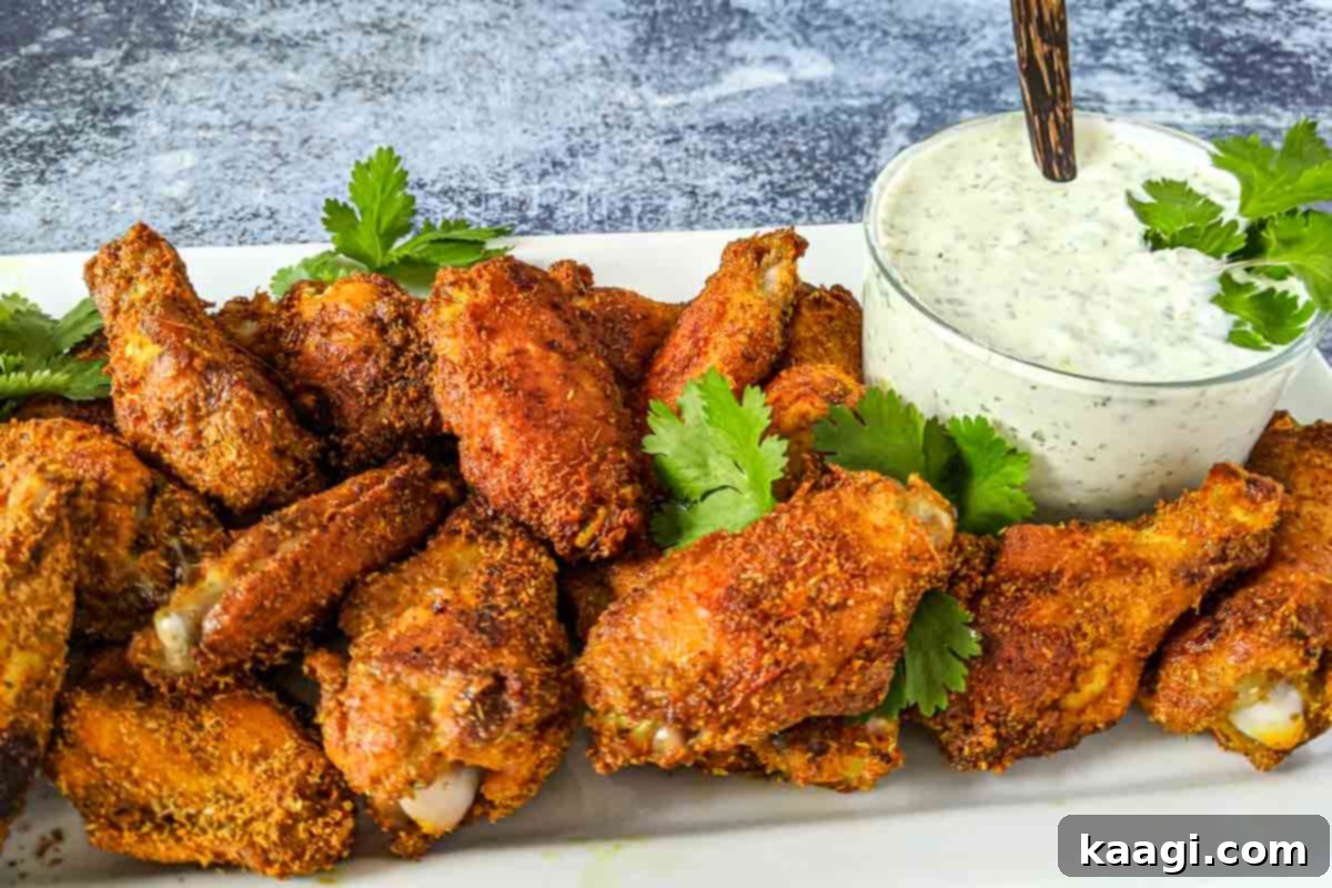 Crispy baked Shawarma Chicken Wings, seasoned with rich spices and ready to be served with a refreshing coriander-yogurt sauce.