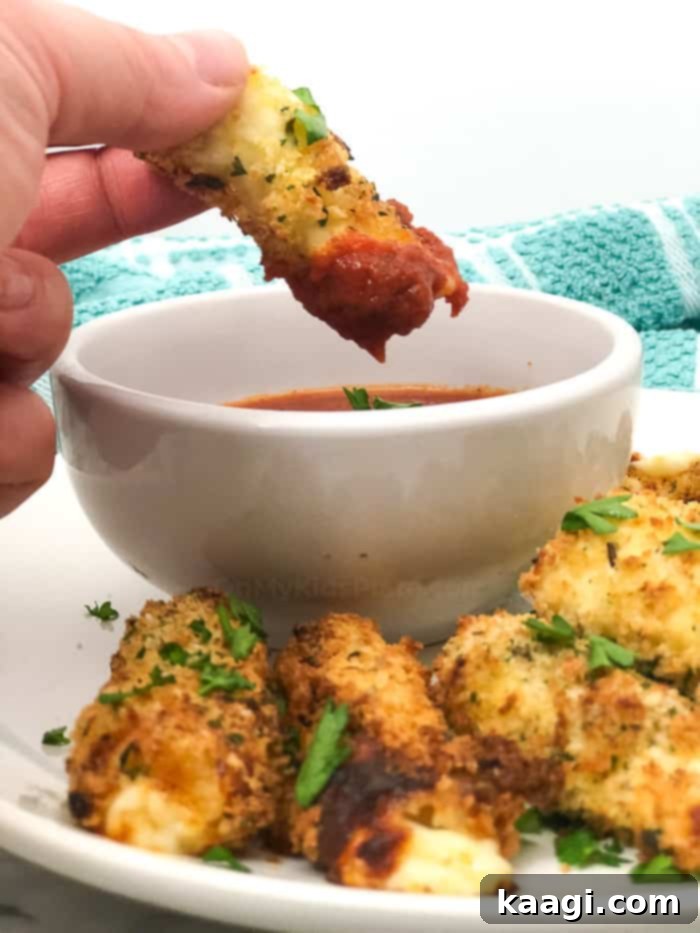 The BEST Air Fryer Mozzarella Sticks, perfectly gooey and crunchy, a healthier take on a party classic.