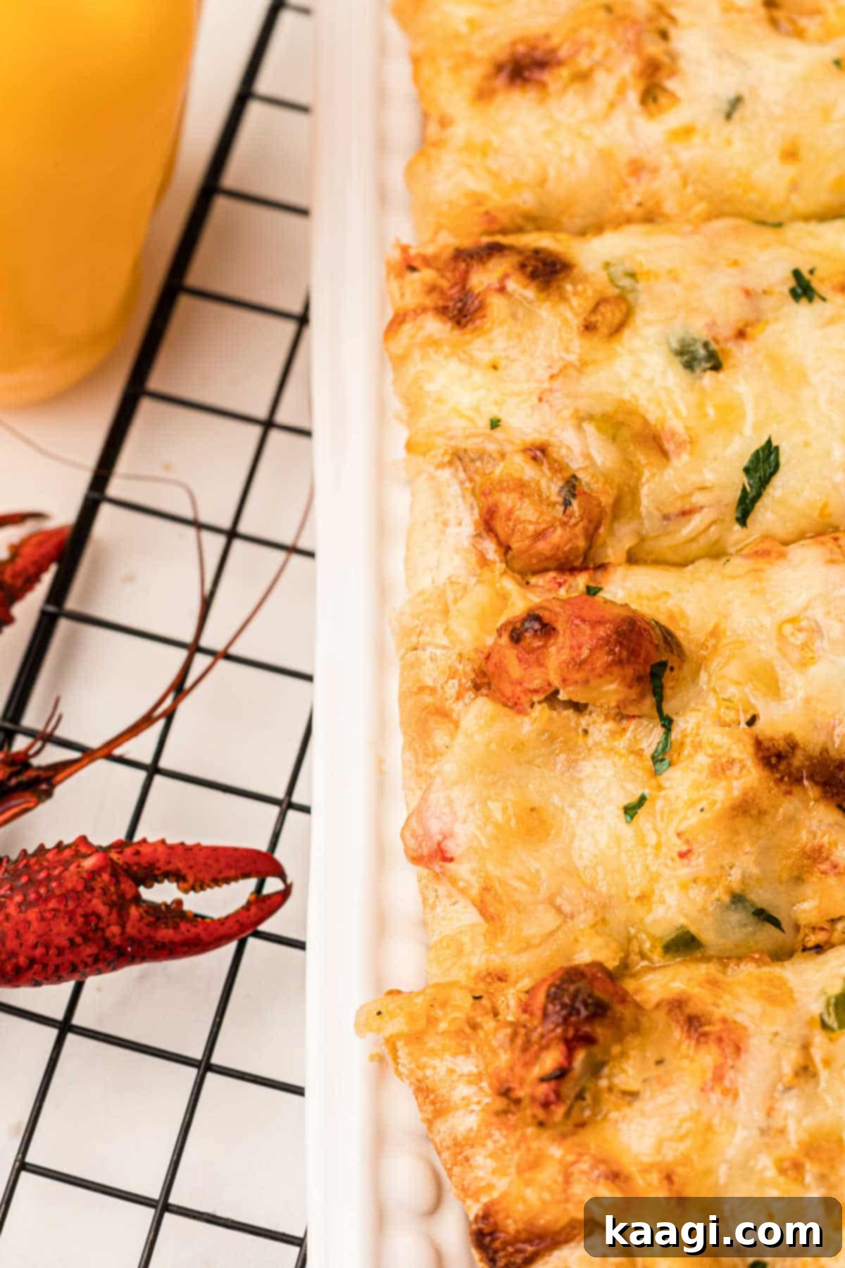 A tempting close-up view of a whole loaf of crawfish bread, highlighting its crispy crust, melted cheese, and savory filling.