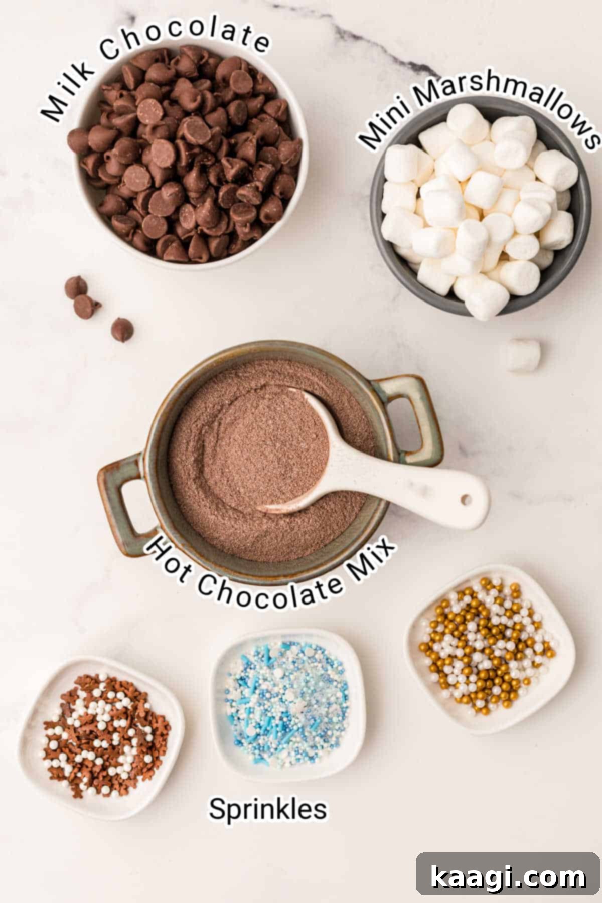 Homemade Hot Chocolate Bomb Magic 3 Ingredients for hot chocolate bombs displayed neatly: chocolate chips, hot chocolate mix, mini marshmallows, and decorative sprinkles.