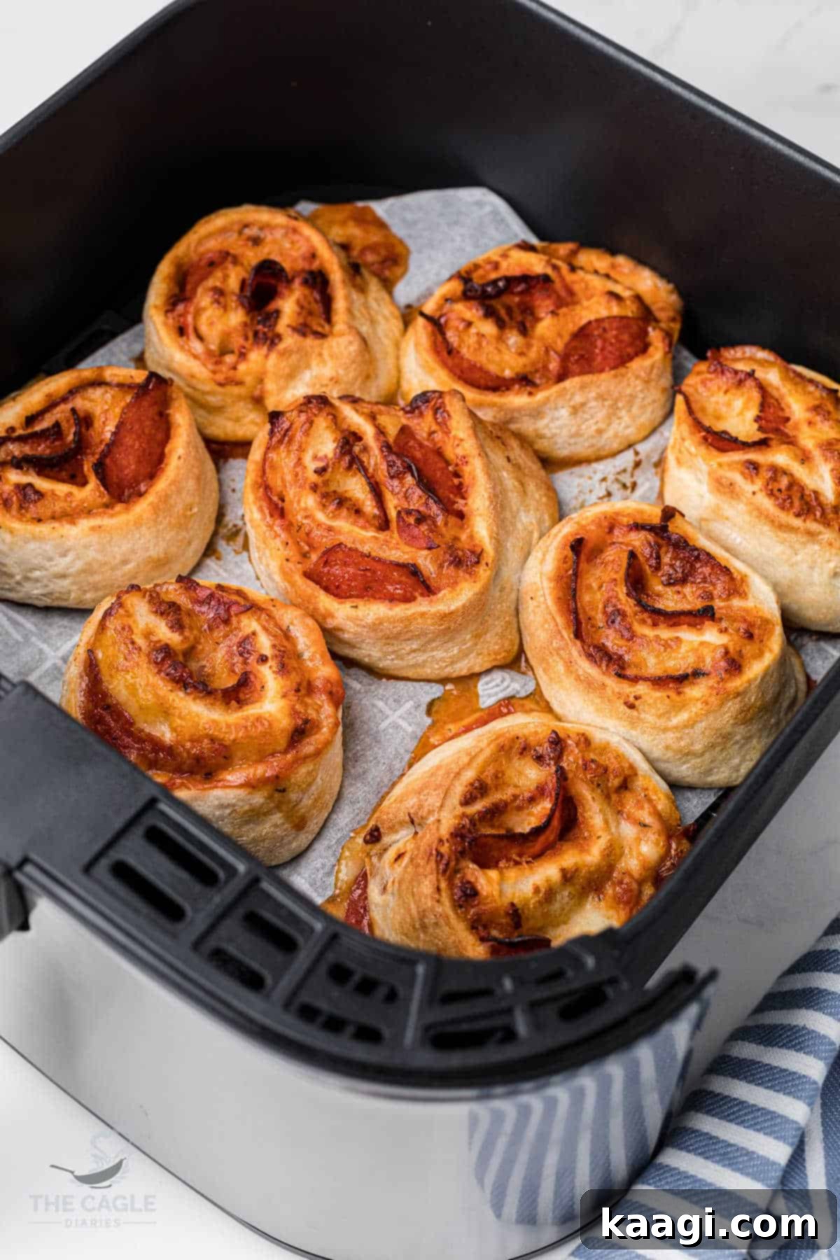 air fryer basket with pizza rolls in a single layer, cooked to a golden crisp