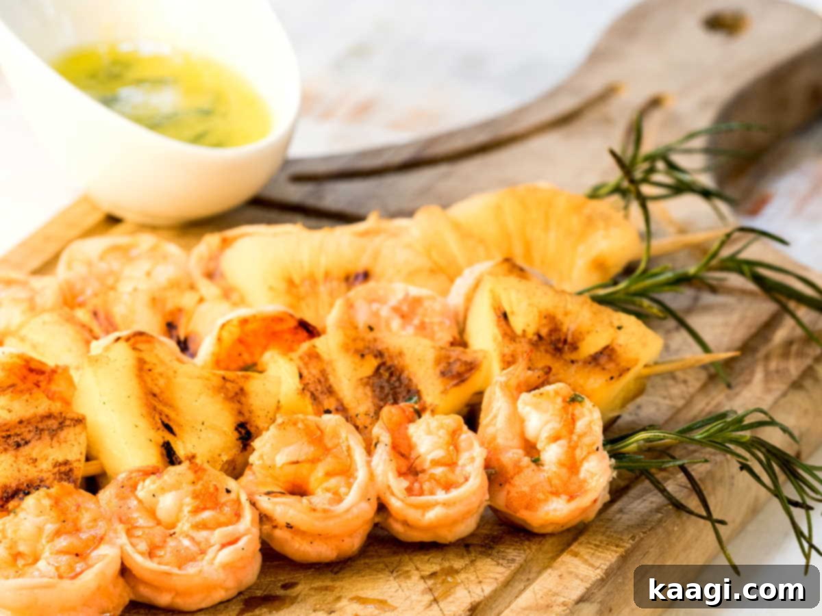 Shrimp on rosemary skewers with rum-soaked pineapple