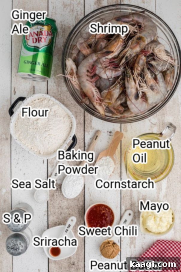 Ingredients for Boom Boom Shrimp laid out on a table: fresh large shrimp, flour, cornstarch, baking powder, ginger ale, and peanut oil.