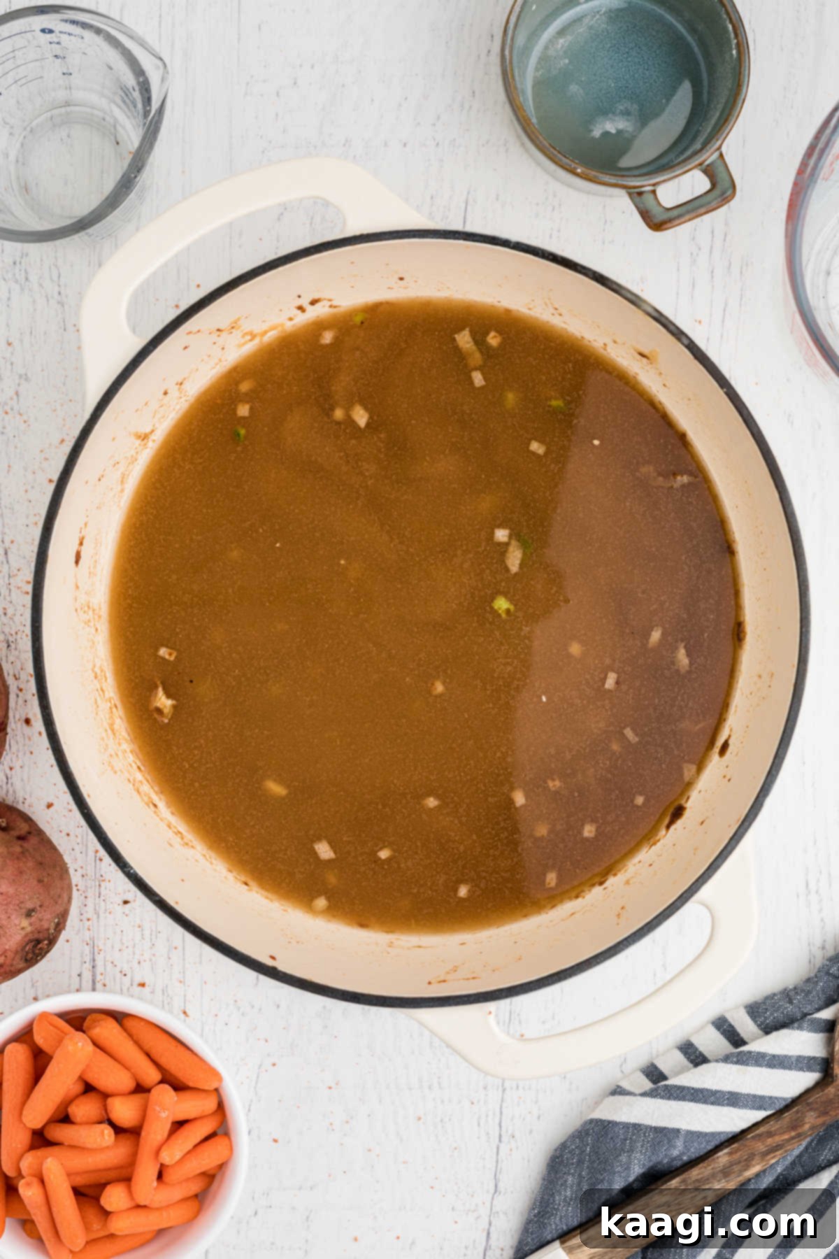 A large pot with a brown looking gravy.