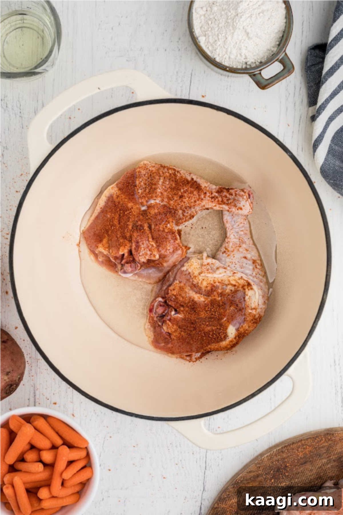 Oil in a pot, with some chicken pieces.