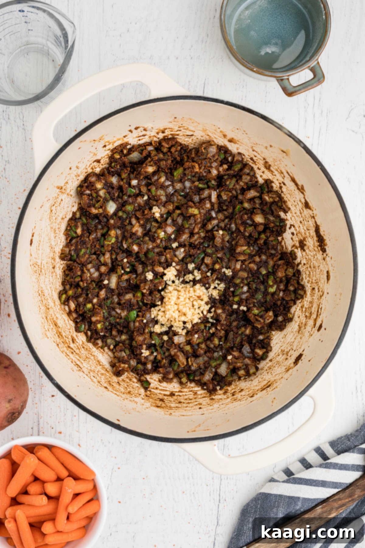 Minced garlic added to a roux with veggies.