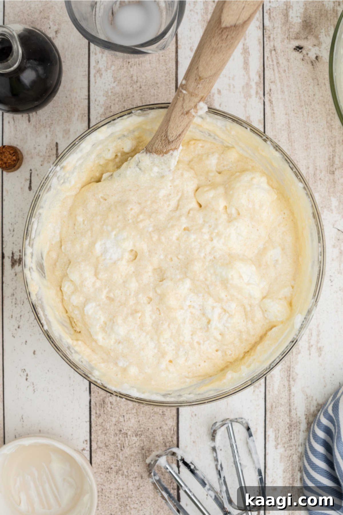 Fluffy egg whites being folded into a batter.