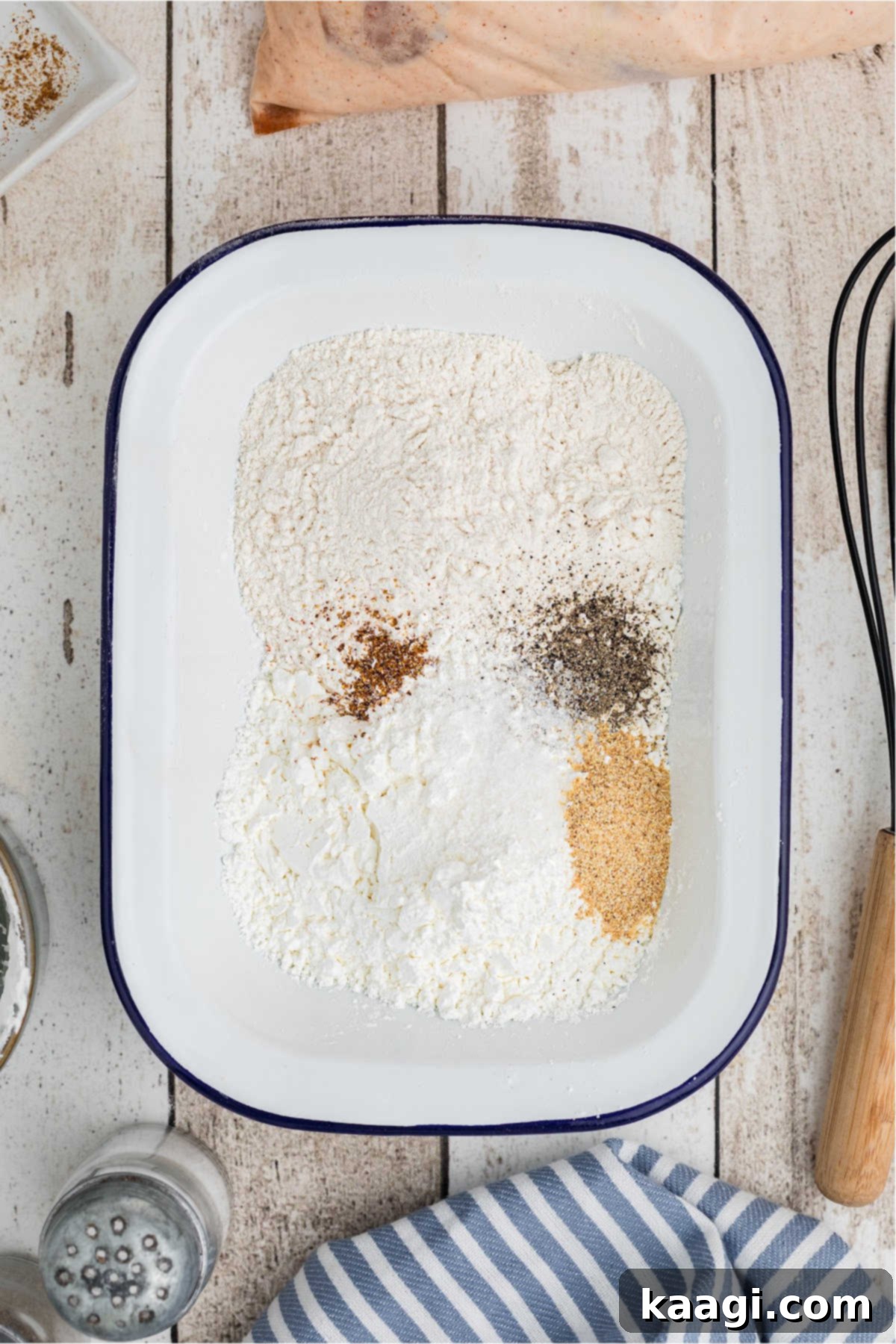A mixing dish filled with flour and seasonings.