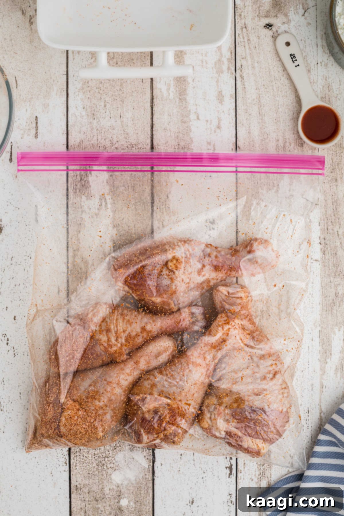 Seasoned chicken legs in a resealable bag.