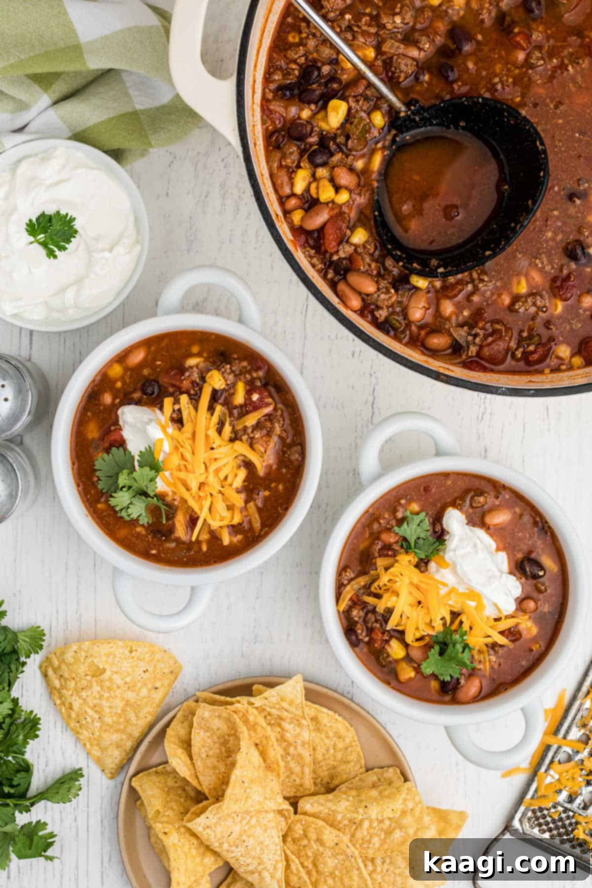 A pot of taco soup with two bowls dished out, ready to serve.