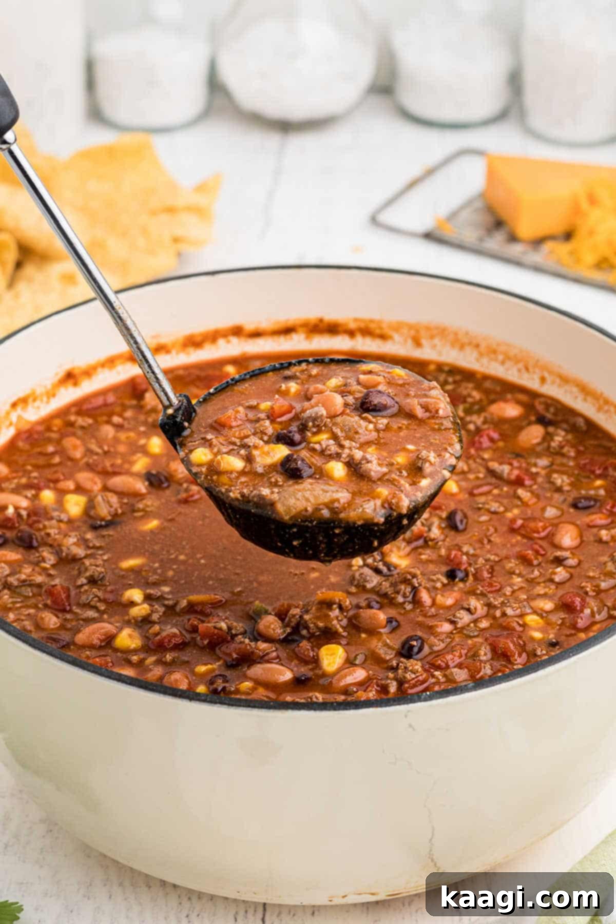 A large pot of taco soup with a ladle spooning out a serving.