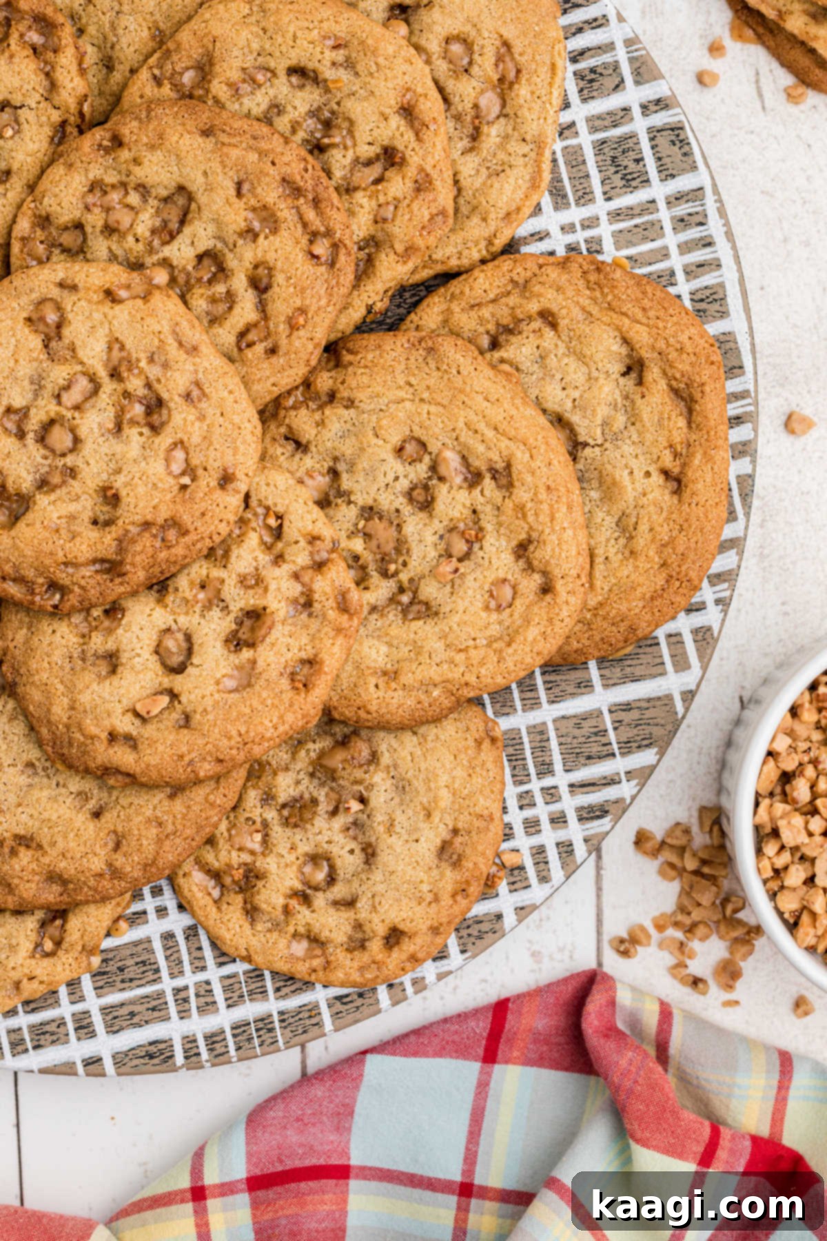 Buttery Crisp Delights 2 Close-up of a plate of golden-brown butter crunch cookies, showcasing their inviting texture and toffee bits.