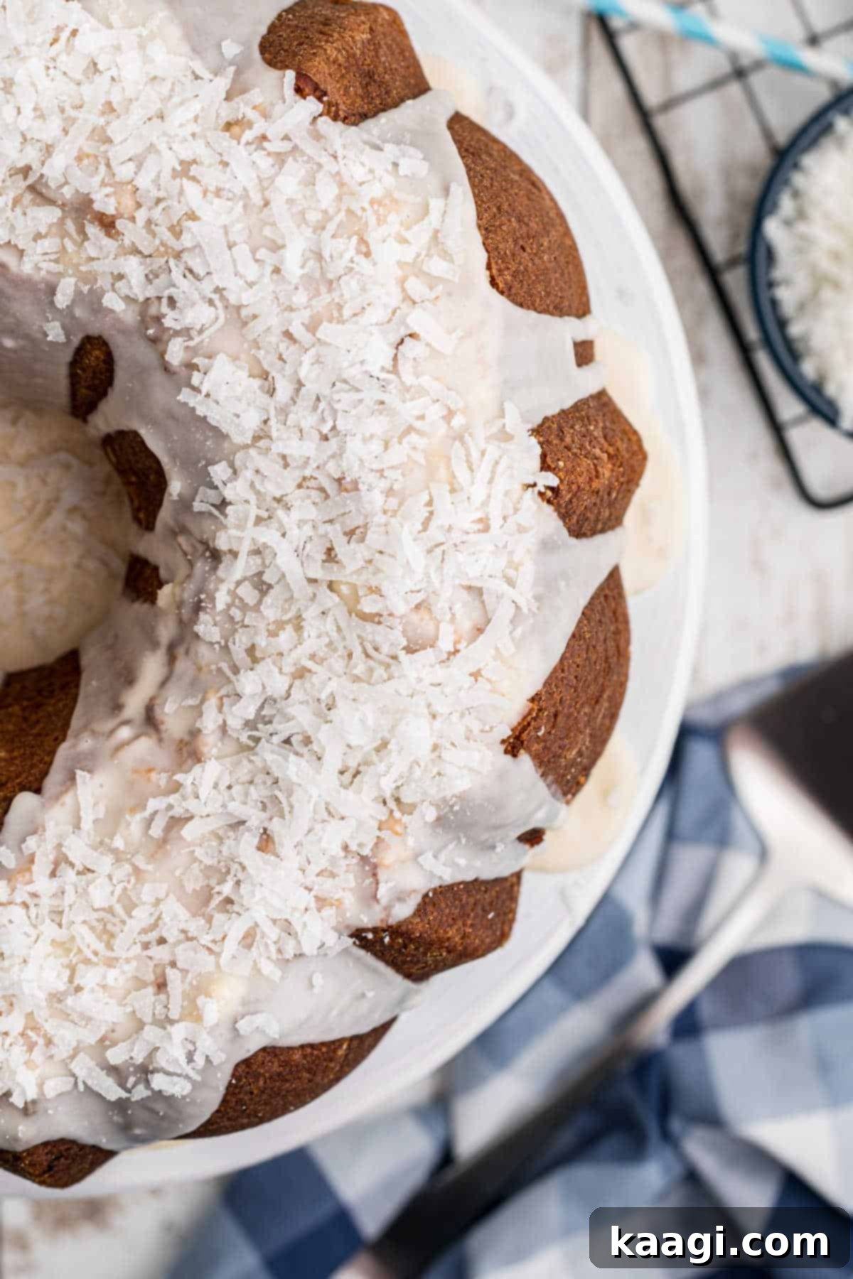 close up of a louisiana crunch cake with icing and coconut on top, sliced and ready to serve