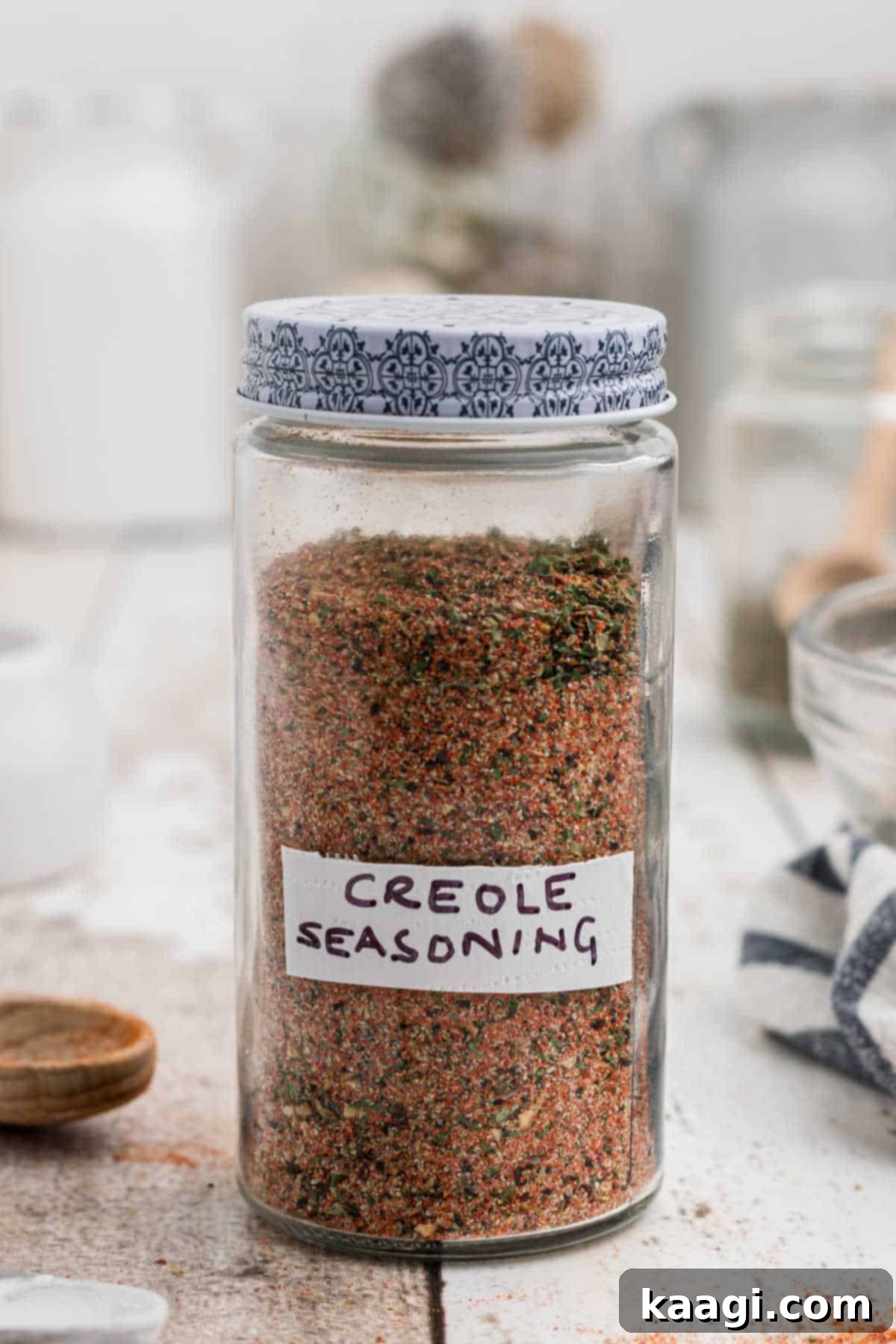 A charming jar filled with golden-brown Creole seasoning, prominently labeled 'Creole Seasoning', ready to infuse dishes with flavor.