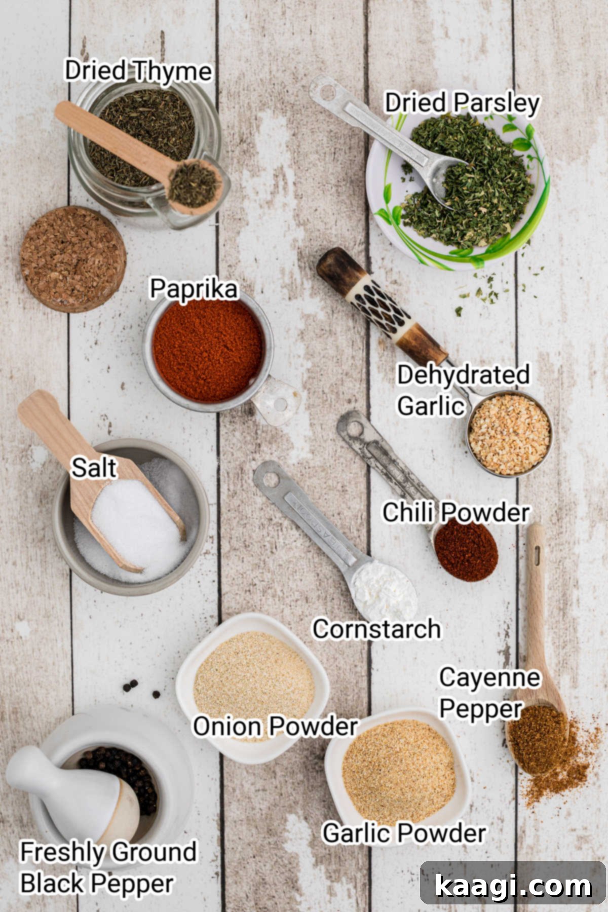 Various spices and herbs neatly arranged with labels indicating typical Creole seasoning ingredients.