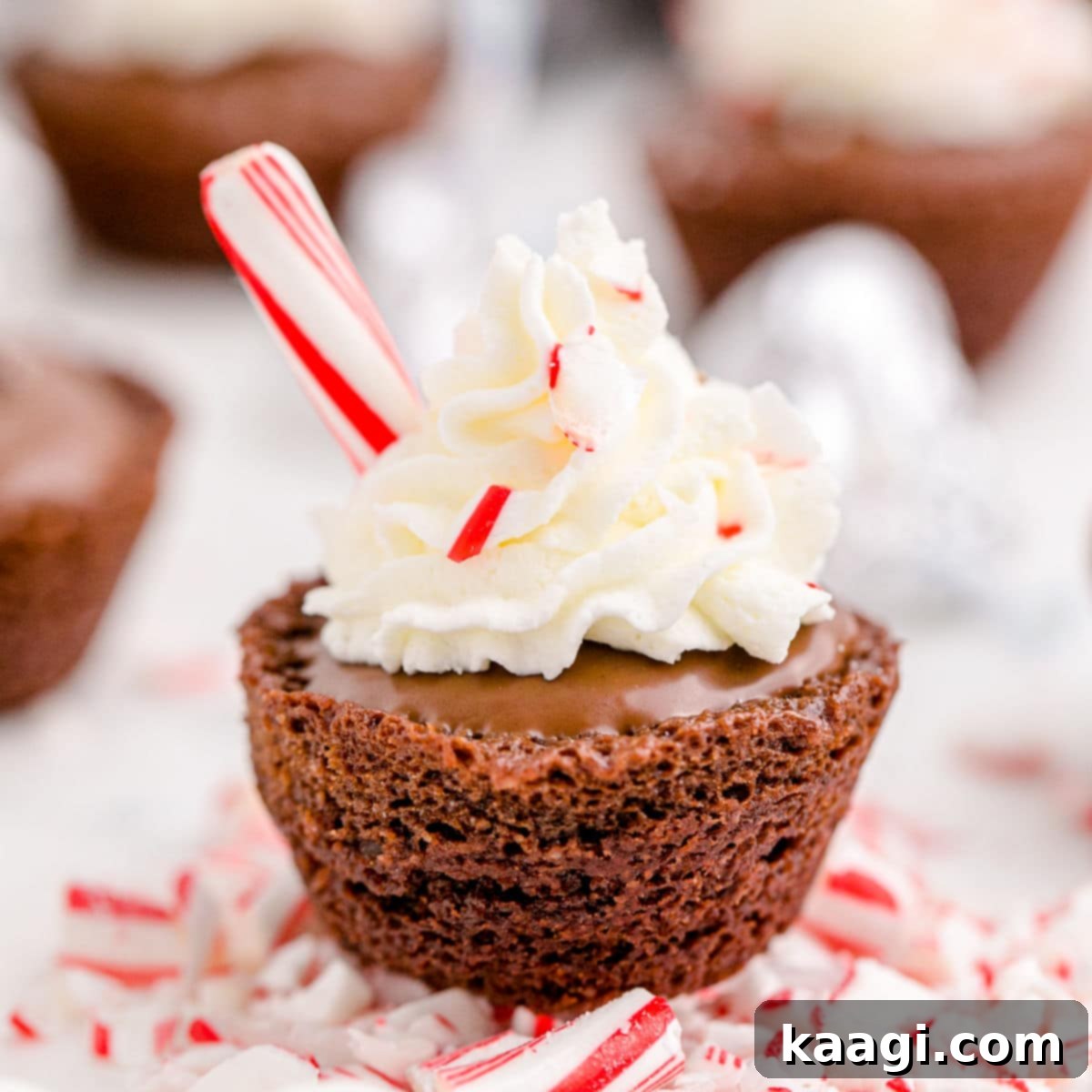 76 Effortless Christmas Goodies 3 Hot Chocolate Brownie Bites topped with whipped cream and peppermint sticks