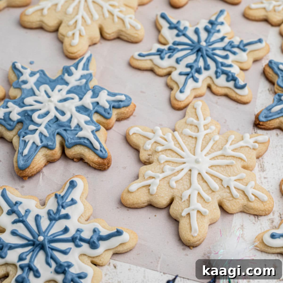 76 Effortless Christmas Goodies 30 Snowflake Cookies with intricate royal icing designs