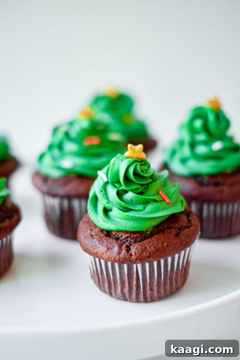 76 Effortless Christmas Goodies 86 Christmas Tree Cupcakes with green frosting and star toppers