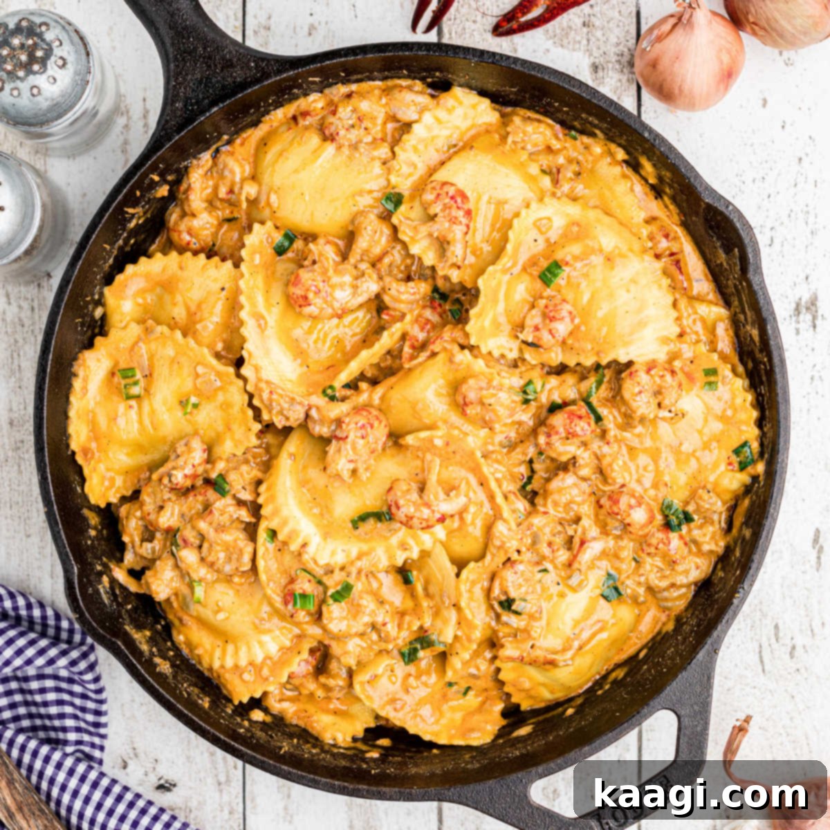 close up of a skillet of crawfish ravioli with boiled crawfish on the outside peeking in
