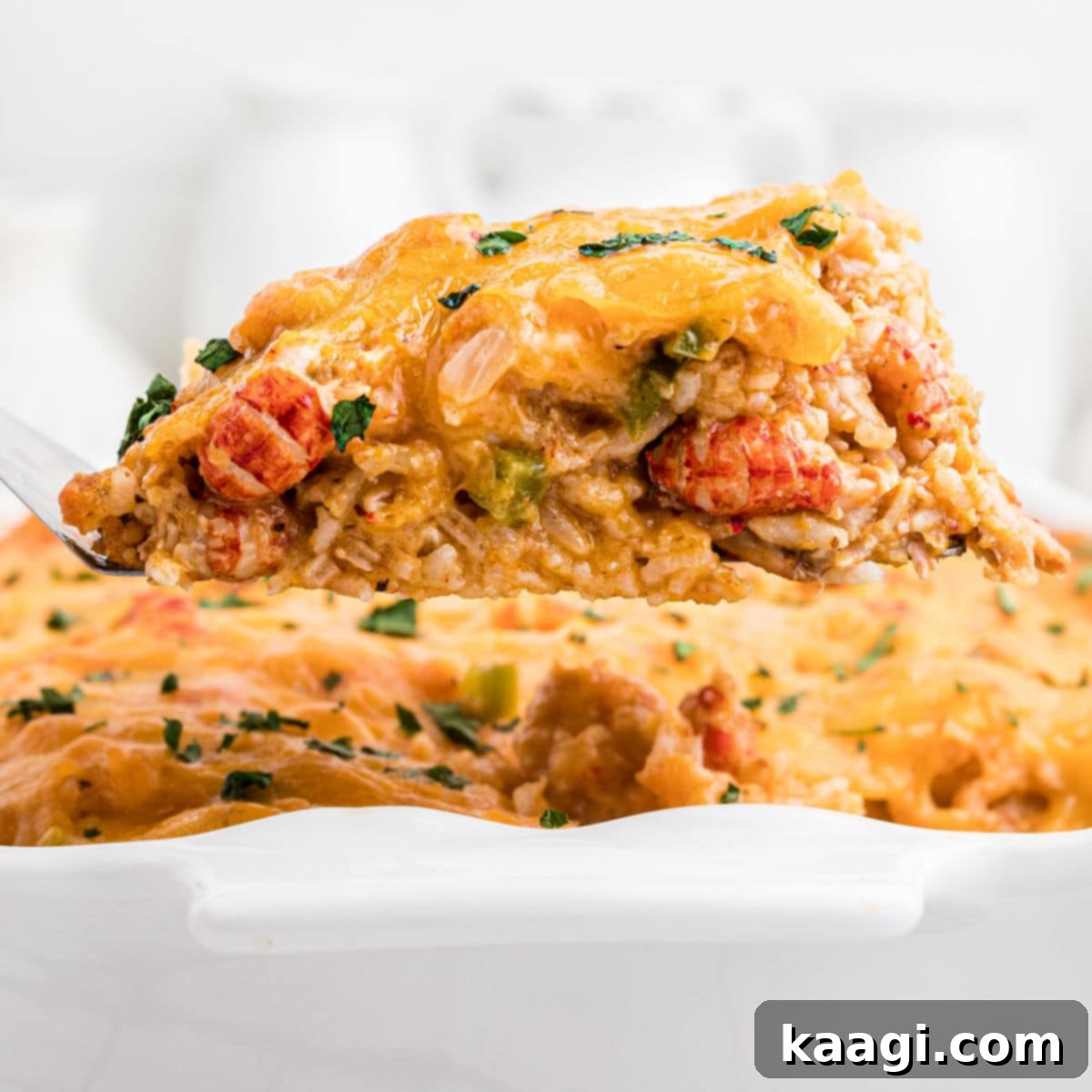 Close up of a crawfish casserole being lifted out with a spatula.