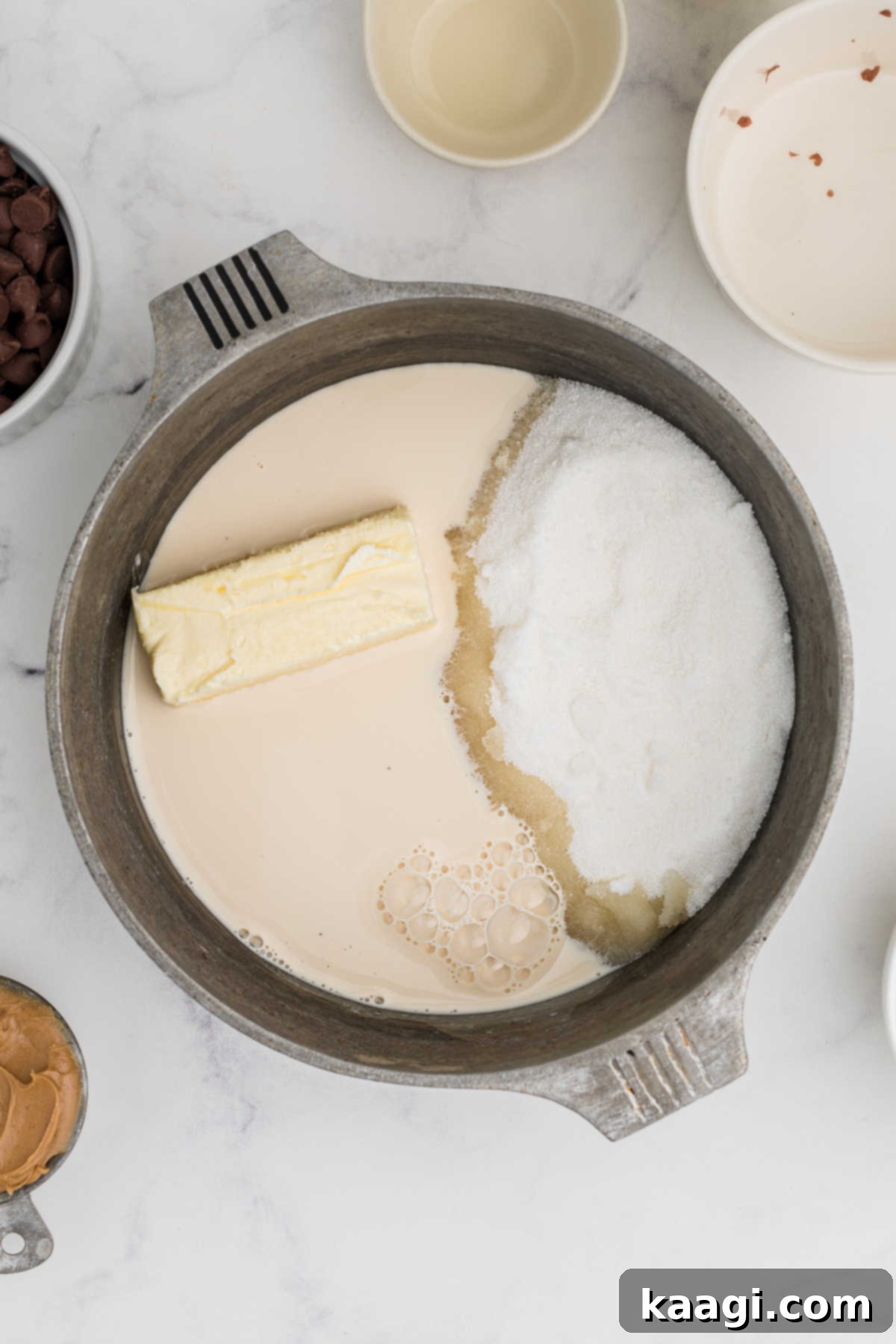 Ultimate Snickers Brownies 9 Evaporated milk, sugar and butter added to a small pot ready to be heated.