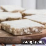 Close up of a vanilla brownie on a wooden board, showcasing its texture