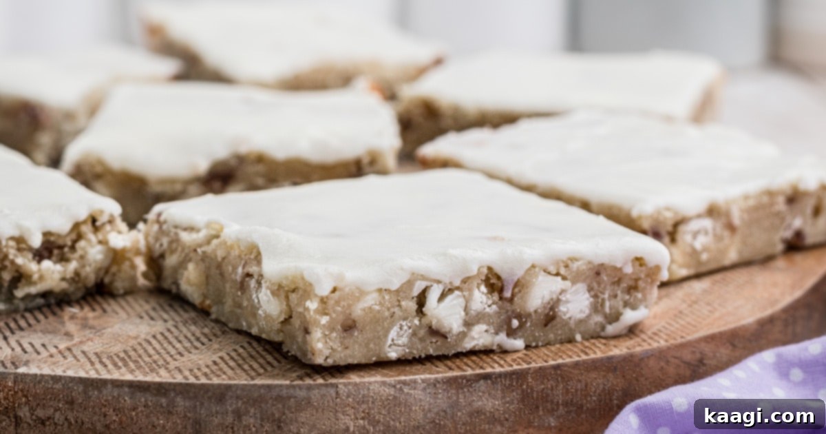 The Only 5 Brownie Recipes You'll Ever Need 5 Close up of a vanilla brownie square with a delicate vanilla glaze, served on a rustic wooden board, a non-chocolate brownie recipe.