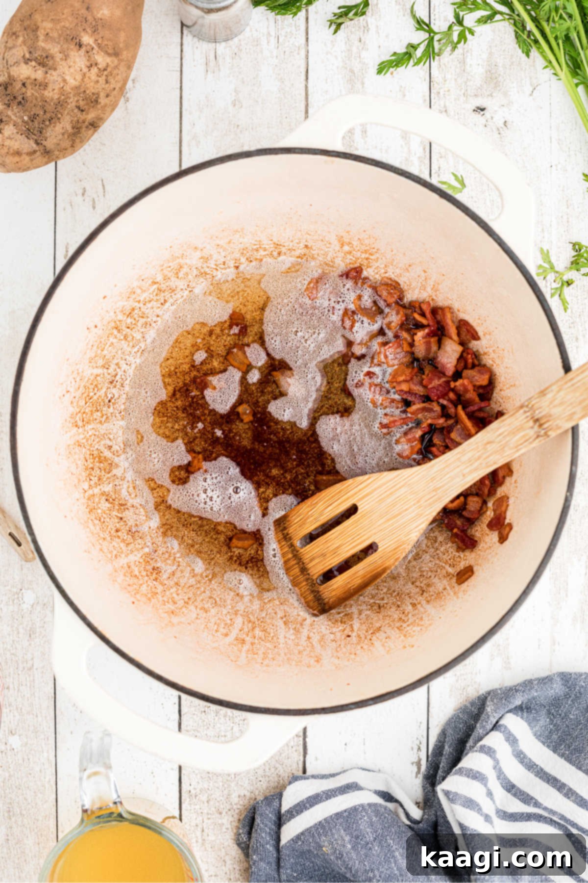 Close-up of diced bacon sizzling and browning in a large, heavy-bottomed Dutch oven, rendering its fat to create a flavorful base for the soup.