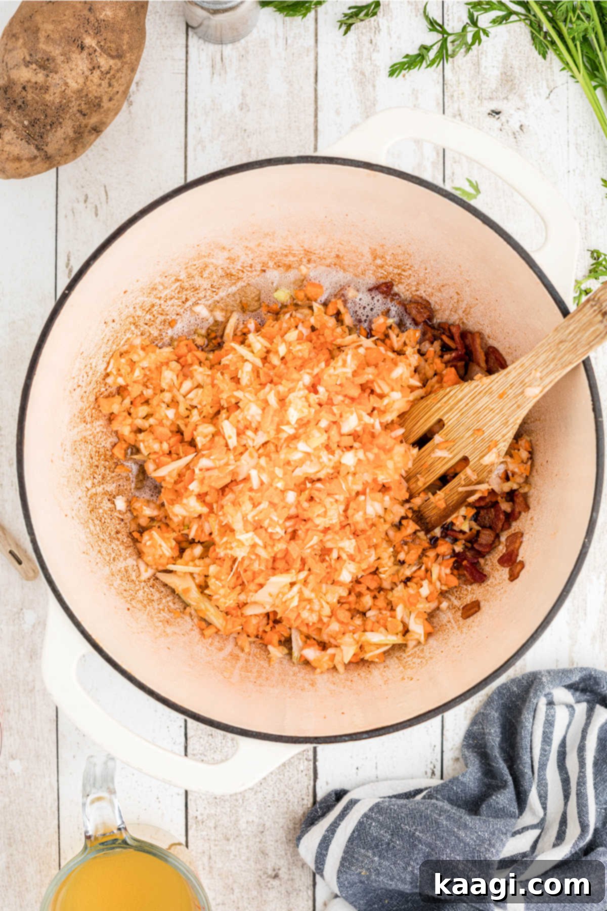 Finely diced carrots, onions, and celery added to the Dutch oven, simmering in the residual bacon drippings to soften and become translucent.