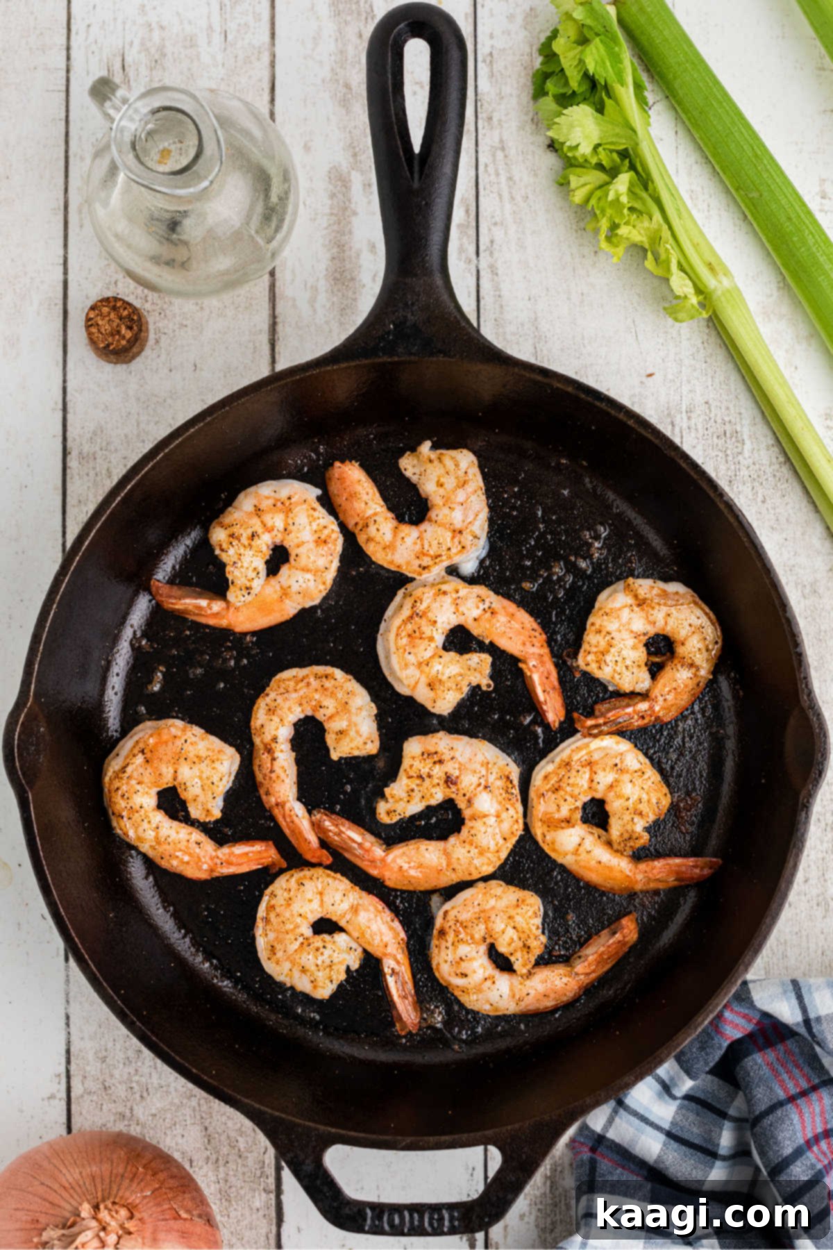 A cast iron skillet cooking some shrimp.