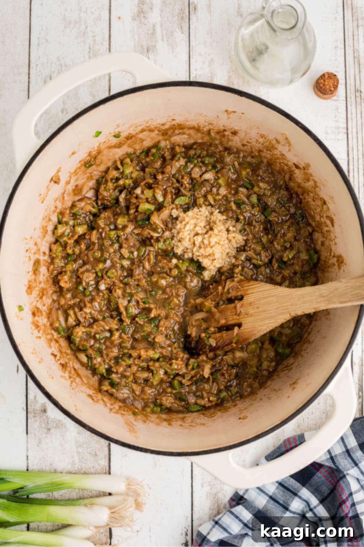 Garlic on top of other ingredients in a large pot.