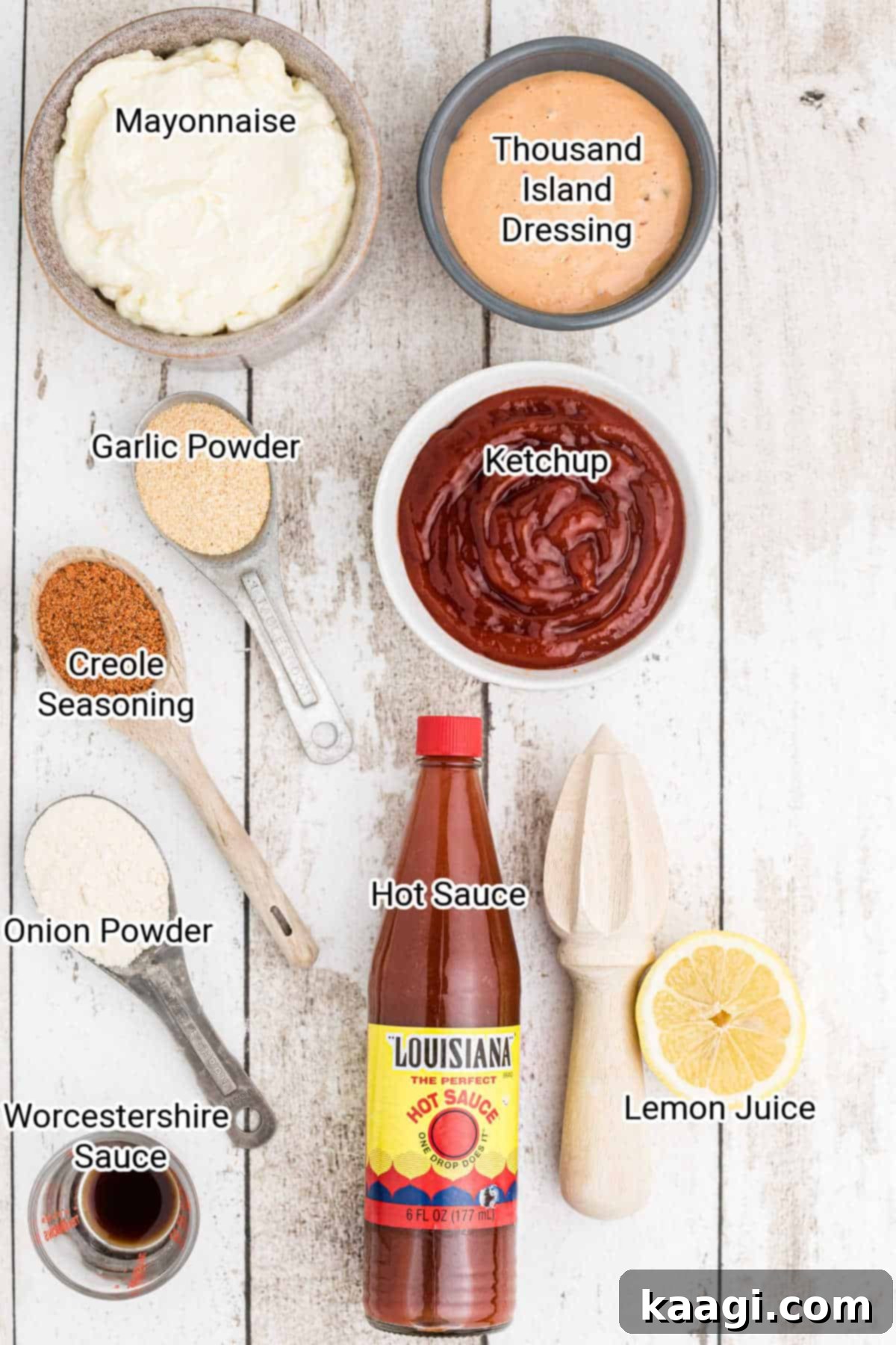 All the fresh ingredients for the seafood sauce laid out on a white surface with their names labeled