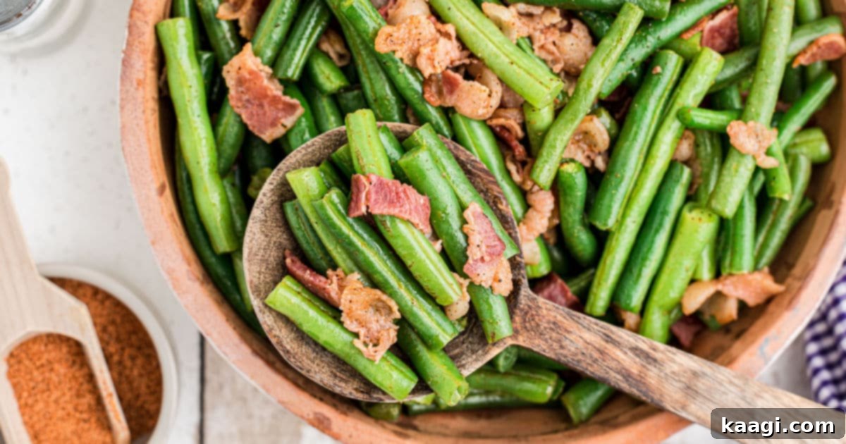 a close up of a bowl of cajun green beans with a serving spoon digging in