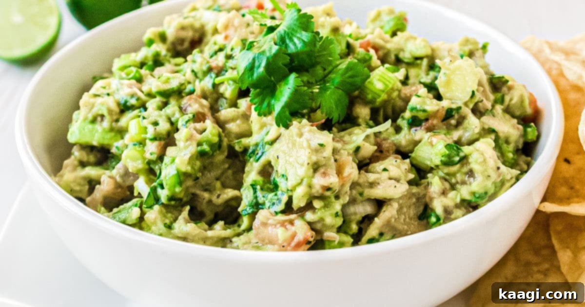 a close up image of a bowl of guacamole with tomato