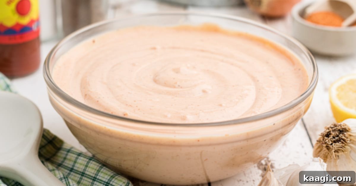 A large bowl of seafood sauce with some ingredients in the background