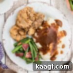 Succulent Pan-Seared Venison Cutlets 8 close up of a venison cutlet on a plate with mashed potatoes and gravy and green beans