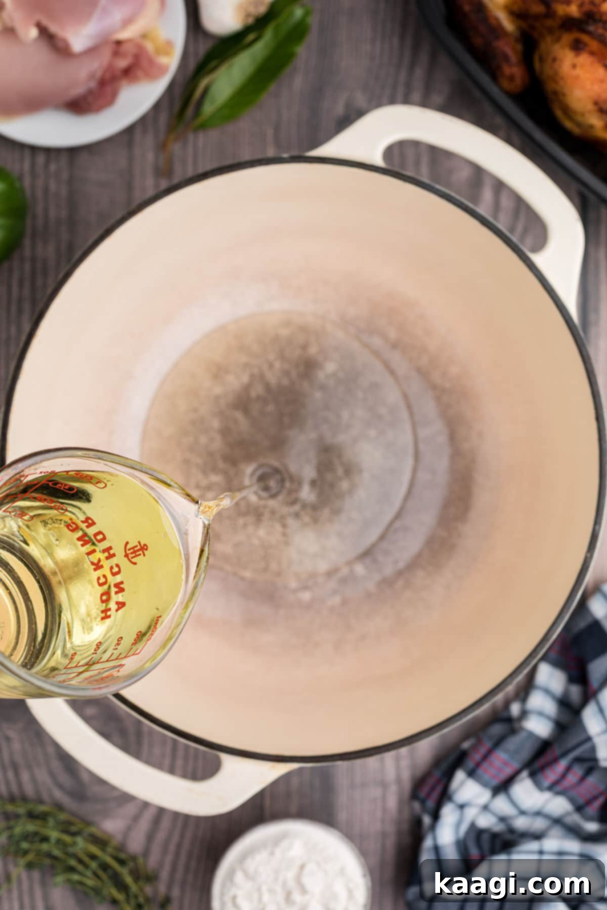Crafting the Deep Flavor of Dark Roux 4 Cooking oil being poured into a heavy-bottomed pot, ready for the flour.