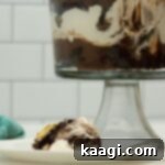 PLATED TRIFLE WITH FORK TRIFLE DISH IN THE BACKGROUND